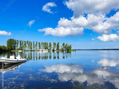 Beautiful Kisezers lake with freshwater and coastal spit  with tall trees in Riga, Latvia. The largest freshwater lake by volume in the Latvia. photo