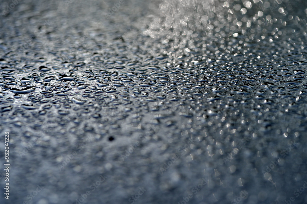 Water droplets on the surface after rain. Abstract background, shallow depth of field. Water droplets on the surface after rain. Abstract background, shallow depth of field.