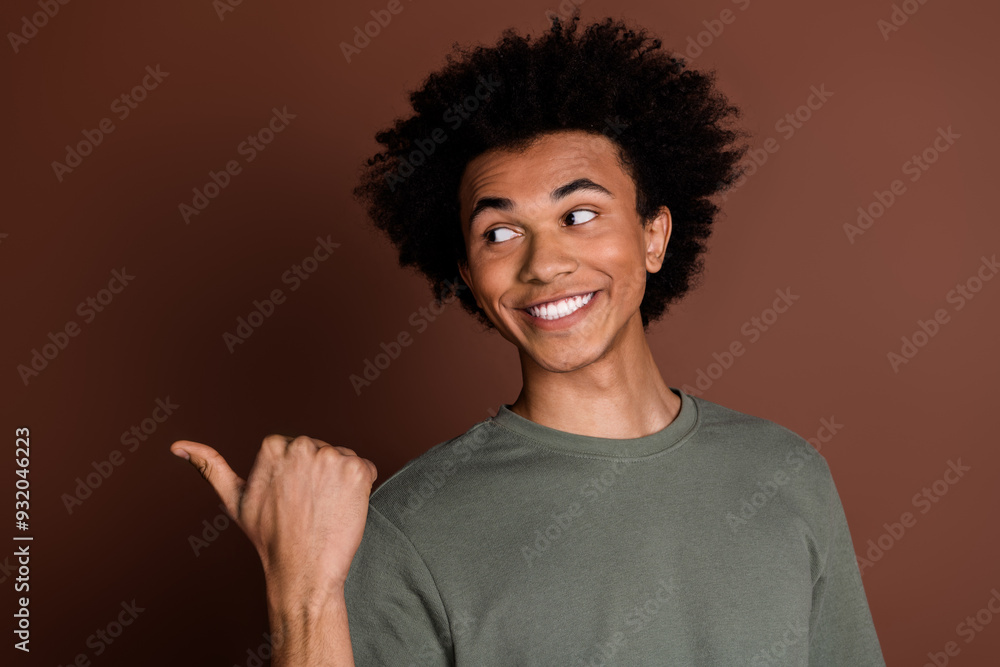 Photo of young positive guy with chevelure introduce his parents business new barber shop isolated on brown color background Photo of young positive guy with chevelure introduce his parents business new barber shop isolated on brown color background