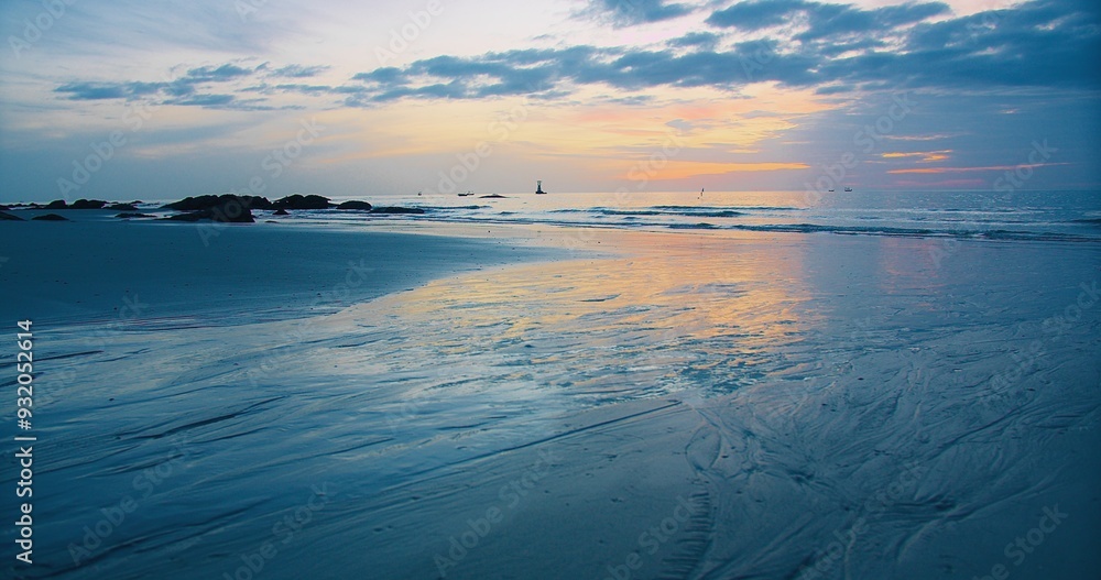A tranquil beach scene at sunset with reflections on the wet sand and a colorful sky, capturing the peaceful beauty of nature. A tranquil beach scene at sunset with reflections on the wet sand and a colorful sky, capturing the peaceful beauty of nature.