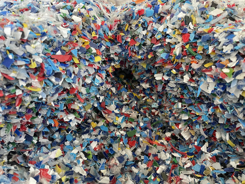 Closeup image of colorful plastic flakes. Concept pollution, environment, save the planet. PP plastic recycling from bottles. Bottle cap. PET bottle recycled. High quality photo