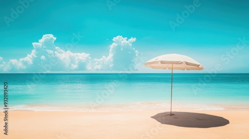 Beach umbrella casting soft shadows on golden sand  framed by the endless blue sky and ocean. Minimalist  tranquil summer vacation vibes in pastel colors