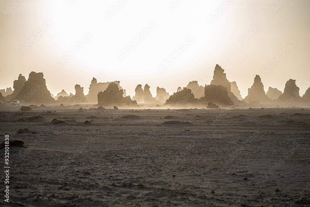 Moon landscape of limestone chimneys geological rock formations in a sunset rays at the bottom of dried salt lake Abbe, Djibouti