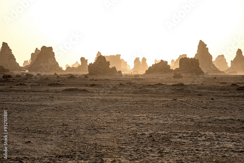 Obraz na płótnie Moon landscape of limestone chimneys geological rock formations in a sunset rays at the bottom of dried salt lake Abbe, Djibouti w salonie