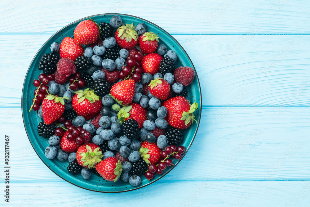 Mix of ripe colorful berries in bowl photography . Blueberry , strawberry , raspberry , blackberry and red currant . Top view Mix of ripe colorful berries in bowl photography . Blueberry , strawberry , raspberry , blackberry and red currant . Top view