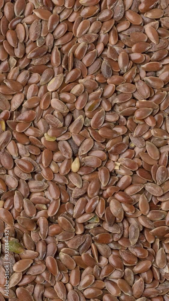 Top view, closeup of brown linseed seeds. Food backdrop Top view, closeup of brown linseed seeds. Food backdrop