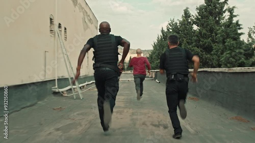 Back view of Suspect running away from the police in the city