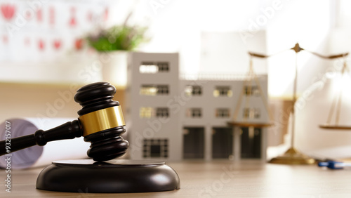 Design and build a new residential building - Real estate concept. judge gavel on building blueprint plans with a white safety helmet in the background. law that deals.