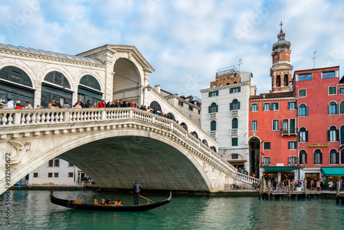 Rialto Bridge full of tourists looking at a gondola on the Grand Canal, Venice, UNESCO World Heritage Site, Veneto, Italy