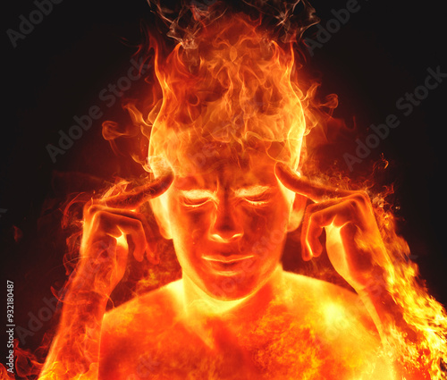 Conceptual man on fire with his eyes closed and hands on his temples photo