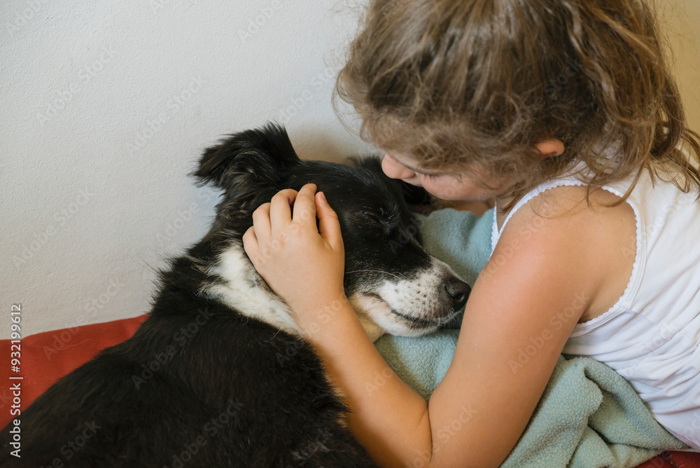 Kid hugging and kissing her stray dog at home Kid hugging and kissing her stray dog at home