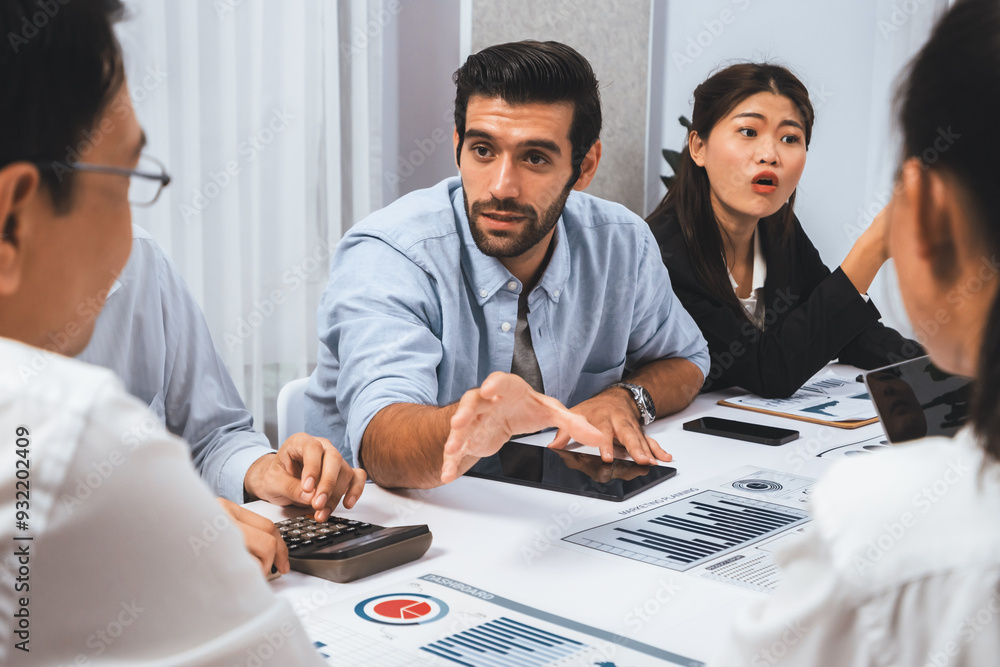 Analyst team utilizing BI Fintech to analyze financial data at table in meeting room. Businesspeople analyzing BI dashboard power on paper for business insight and strategic marketing planning.Prudent Analyst team utilizing BI Fintech to analyze financial data at table in meeting room. Businesspeople analyzing BI dashboard power on paper for business insight and strategic marketing planning.Prudent