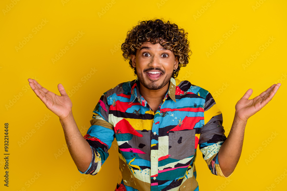 Photo portrait of attractive young man raise hands amazed dressed stylish colorful clothes isolated on yellow color background Photo portrait of attractive young man raise hands amazed dressed stylish colorful clothes isolated on yellow color background