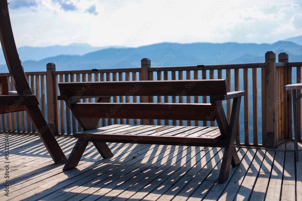 Wooden furniture on terrace of country house with amazing view on mountains Wooden furniture on terrace of country house with amazing view on mountains