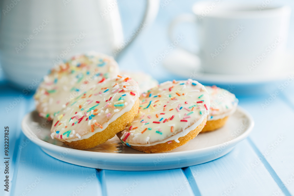 Sweet dessert with sugar coating on plate on blue table. Sweet dessert with sugar coating on plate on blue table.