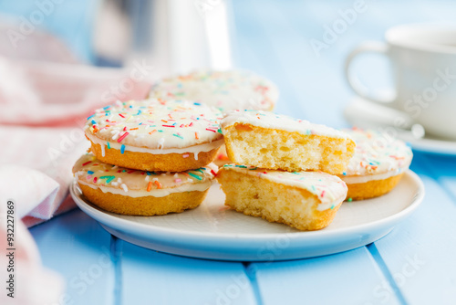 Sweet dessert with sugar coating on plate on blue table. photo