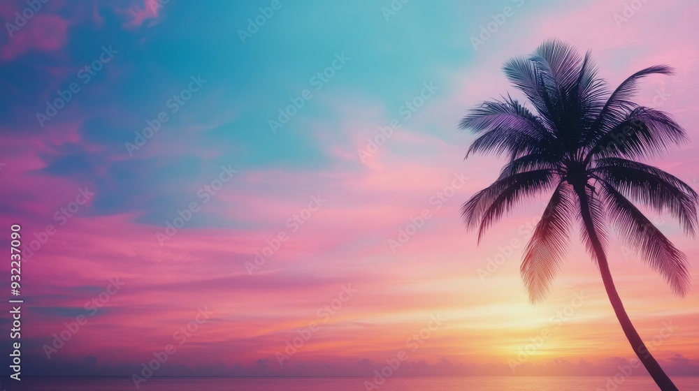Beautiful sunset over the ocean with a single palm tree on the sandy beach Beautiful sunset over the ocean with a single palm tree on the sandy beach