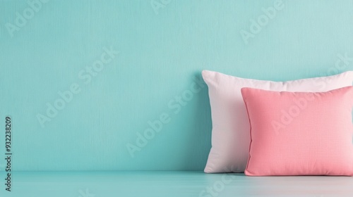 Soft cushions arranged on a turquoise wall backdrop in a bright interior setting