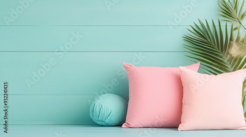 Soft cushions arranged on a turquoise wall backdrop in a bright interior setting