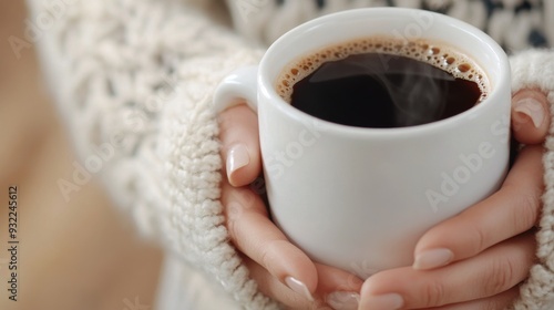 Holding a warm cup of coffee indoors during a cozy winter morning