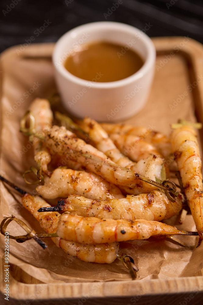Delicious Grilled Shrimp Accompanied by a Sauce on a Rustic Wooden Platter for Serving Delicious Grilled Shrimp Accompanied by a Sauce on a Rustic Wooden Platter for Serving