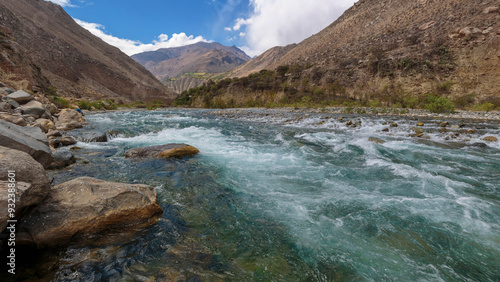 Flowing river with rocky surroundings view photo