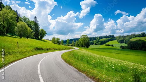 Vast Grasslands with a Winding Road, Capturing the Beauty of Nature and the Open Landscape Under a Clear Blue Sky