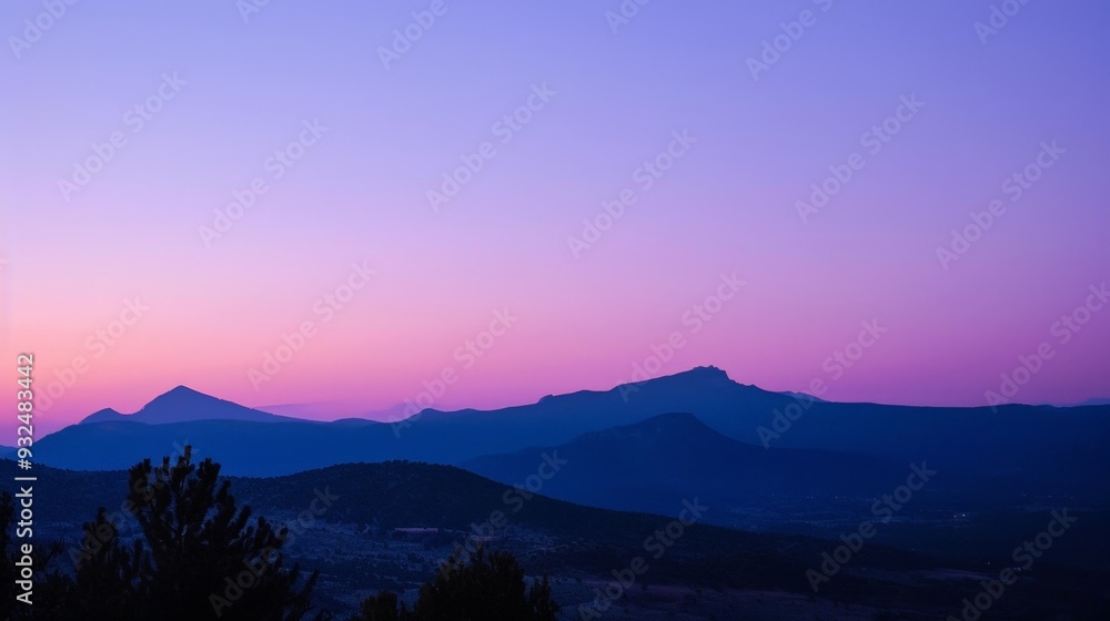 Fototapeta premium Dusk settles softly, blending hues of purple and indigo in the western sky.