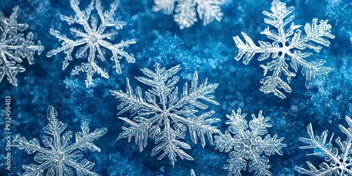 Close-up of intricate snowflake patterns on a blue background, great for winter or cold weather-themed designs