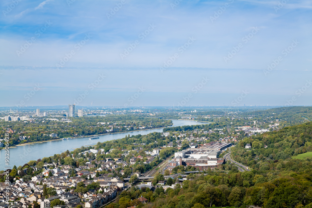 A panoramic aerial view from Schloss Drachenburg, showing the Rhine River, Cologne's skyline, and the vast urban and natural landscapes surrounding the castle. A panoramic aerial view from Schloss Drachenburg, showing the Rhine River, Cologne's skyline, and the vast urban and natural landscapes surrounding the castle.