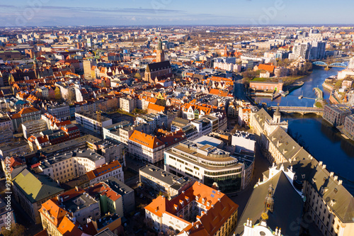 Picturesque aerial view of Wroclaw on Oder River bank overlooking historical Market Square with Old Town Hall, massive Gothic church of St. Elizabeth and St. Mary Magdalene Church in spring, Poland photo