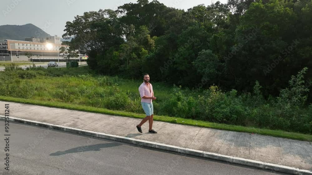 Walking and running on neighborhood streets. Cell phone in pocket or hands. Aerial view. Camera following. Walking and running on neighborhood streets. Cell phone in pocket or hands. Aerial view. Camera following.