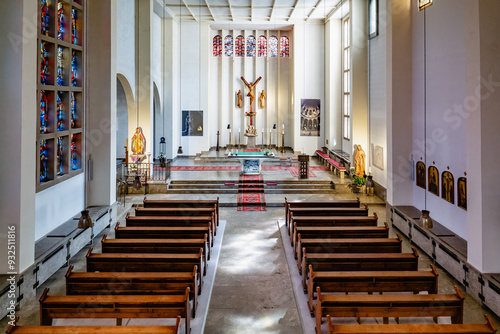 View of the main altar inside Klosterkirche Heisterbach, featuring stained glass windows and religious sculptures in this historic Cistercian monastery. photo