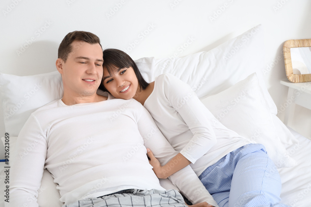 Young loving couple lying in bedroom Young loving couple lying in bedroom