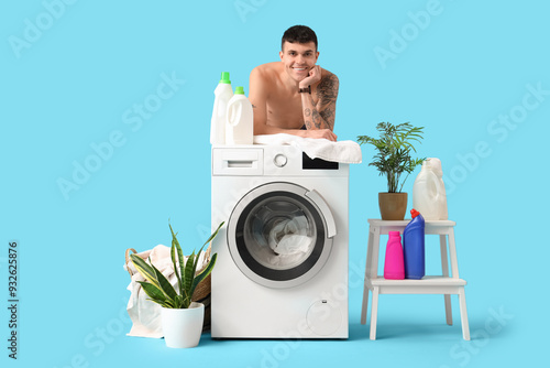Young man doing laundry on ...