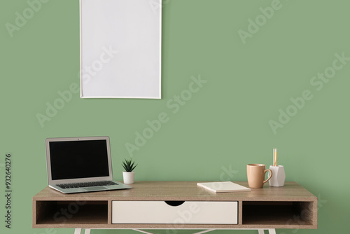 Workplace with laptop, hous...