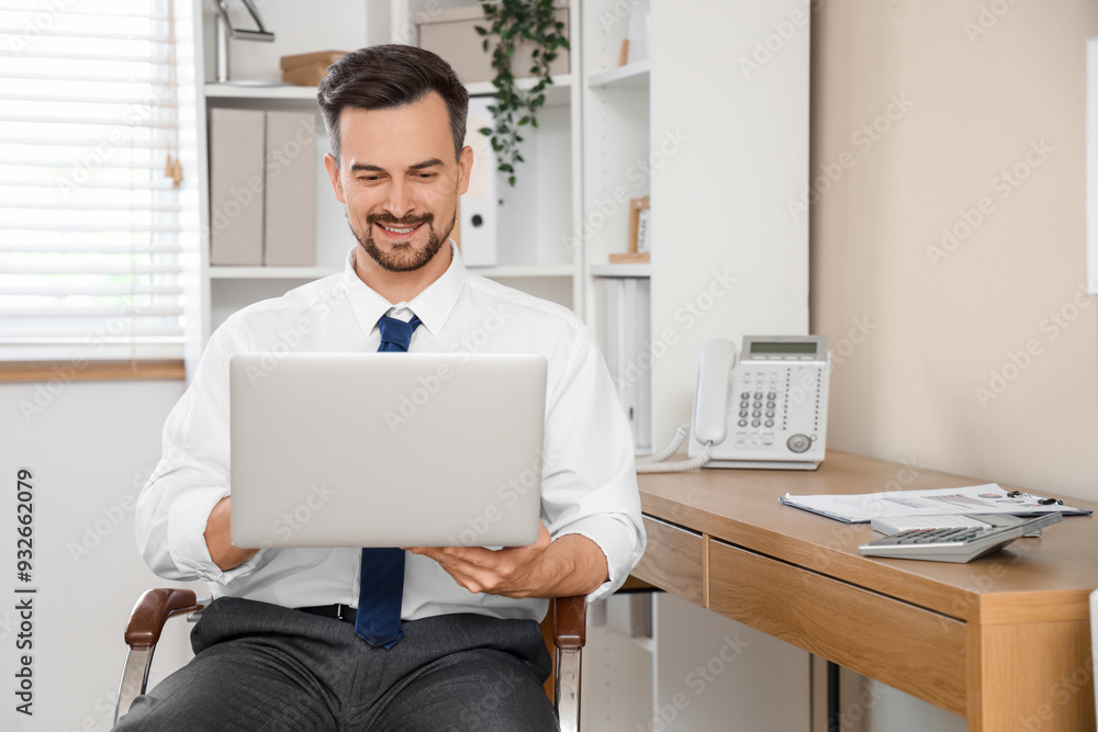 Male accountant working with laptop in office Male accountant working with laptop in office