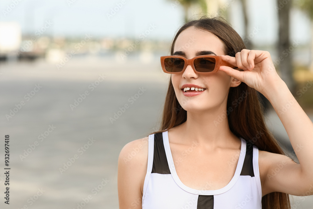 Beautiful young woman in stylish sunglasses outdoors, closeup Beautiful young woman in stylish sunglasses outdoors, closeup