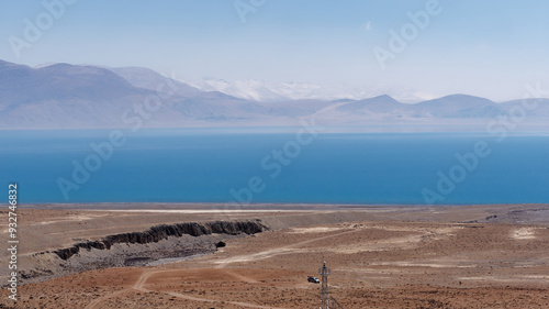 Landscape view of the beautiful lake Pelku (Paiku) with the snow covered mount Shishapangma in the background on the Tibetan Plateau in Shigatse Prefecture, China photo