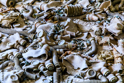 Ukraine, Pripyat, Chernobyl. Gas masks, many of them child-sized, litter the floor of an abandoned school. photo