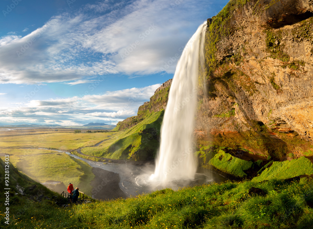 Waterfall, Iceland - Seljalandsfoss. Famous waterfall against the backdrop of northern nature. Beautiful Iceland. APanoramic landscape of nature and waterfall
