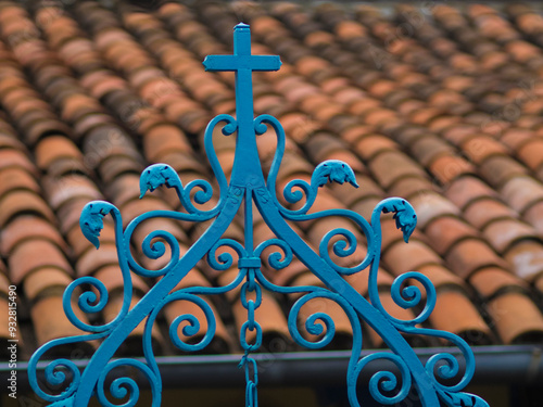 Santiago de Cuba, red tile roof and blue wrought iron cross. photo