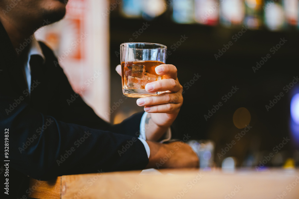 A young businessman holds a glass of whiskey, toasting with friends at an upscale bar. The scene captures the essence of luxury and celebration, with a focus on camaraderie and the nightlife atmospher A young businessman holds a glass of whiskey, toasting with friends at an upscale bar. The scene captures the essence of luxury and celebration, with a focus on camaraderie and the nightlife atmospher