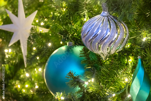 Christmas ornaments and lights on an artificial tree photo