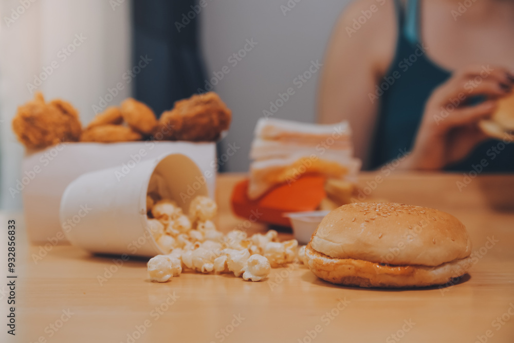 fast food, people and unhealthy eating concept - close up of woman hands holding hamburger or cheeseburger fast food, people and unhealthy eating concept - close up of woman hands holding hamburger or cheeseburger
