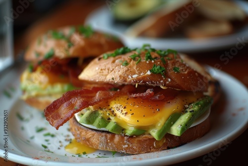 Macro shot of avocado and bacon topped eggs Benedict