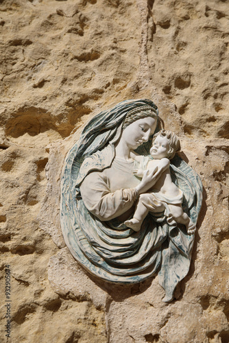 Valletta, Malta. Religious icon fresco of a mother and a child on limestone in the walled city