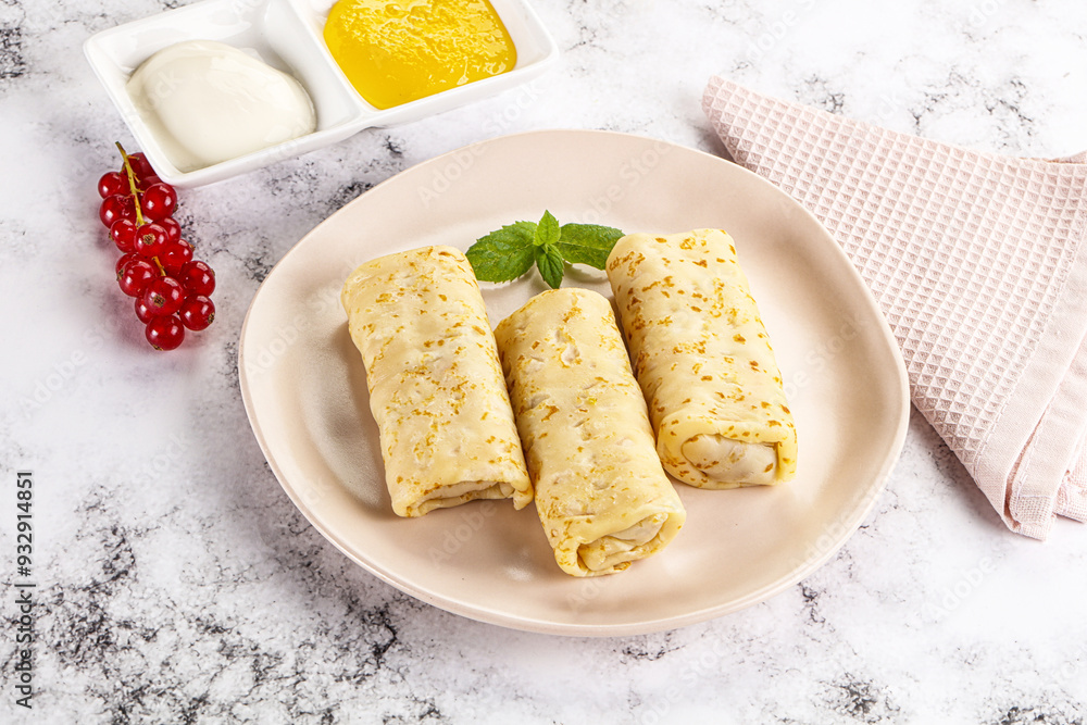 Homemade stuffed pancakes with honey and cream sour Homemade stuffed pancakes with honey and cream sour