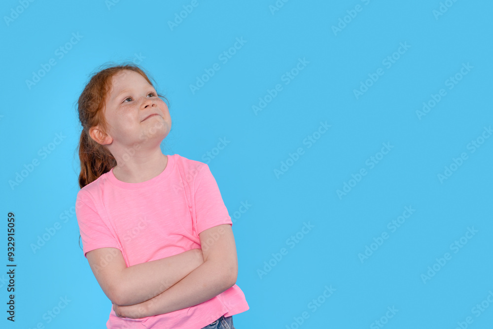 Girl With Crossed Arms Smiles Against Bright Blue Background, Showcasing Confidence and Joy Girl With Crossed Arms Smiles Against Bright Blue Background, Showcasing Confidence and Joy