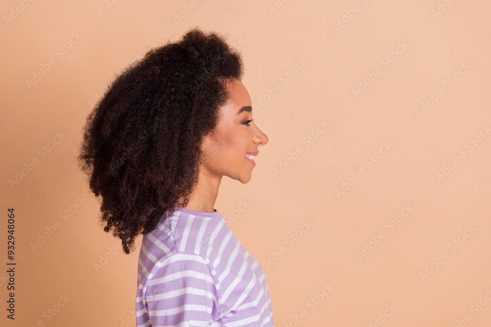 Profile photo of nice young woman look empty space wear striped t-shirt isolated on beige color background Profile photo of nice young woman look empty space wear striped t-shirt isolated on beige color background